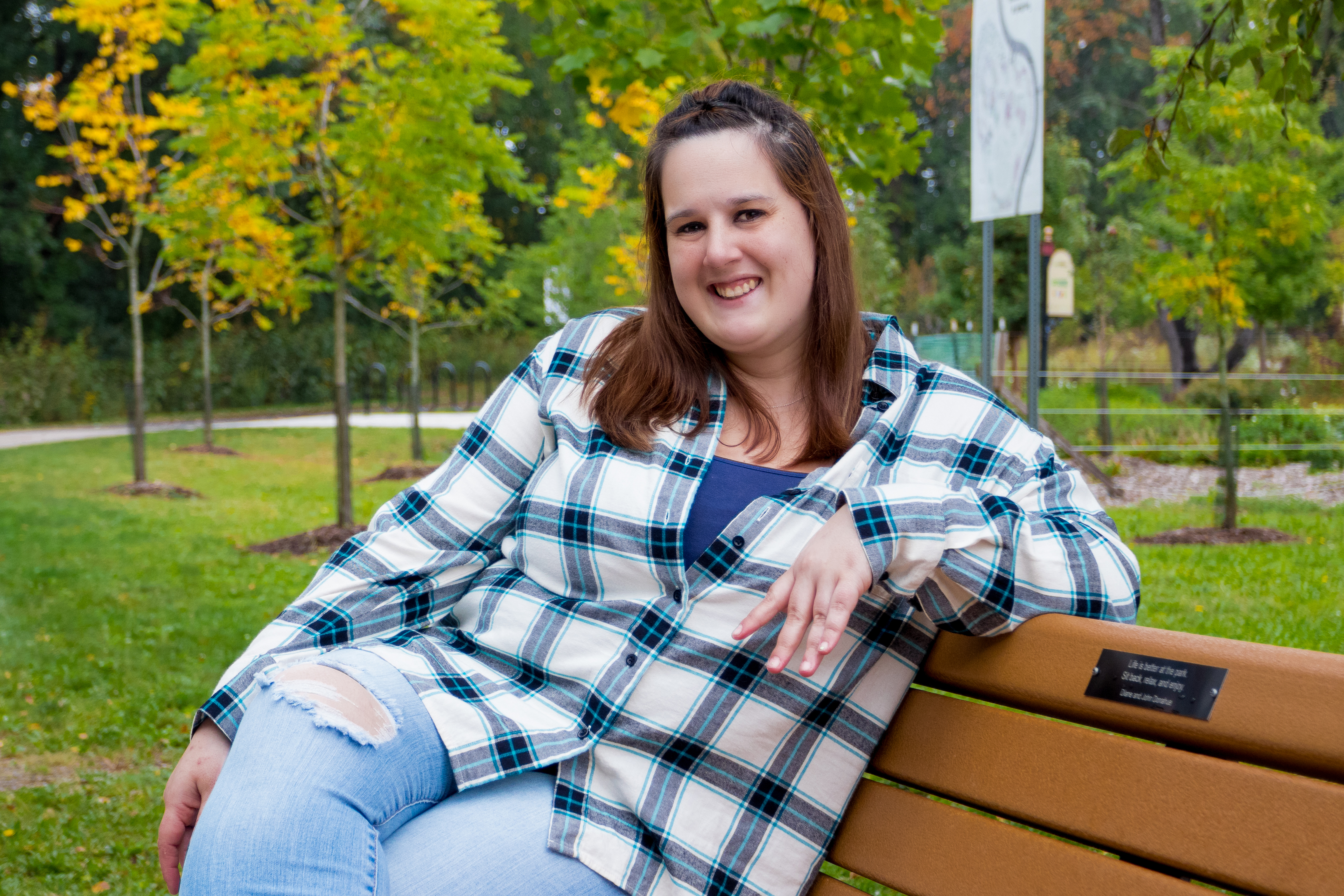 Sarah sitting on bench and smiling 