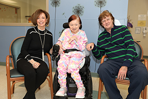 Woman with Cerebral Palsy surrounded by brother and sister