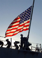 American flag with silhouetted servicemembers