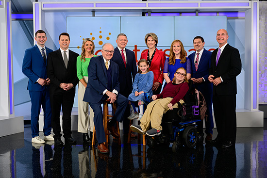 photo of nine people, all hosts at ABC 25/CW 7, standing on set with 2024 Easterseals Ambassadors in front of them