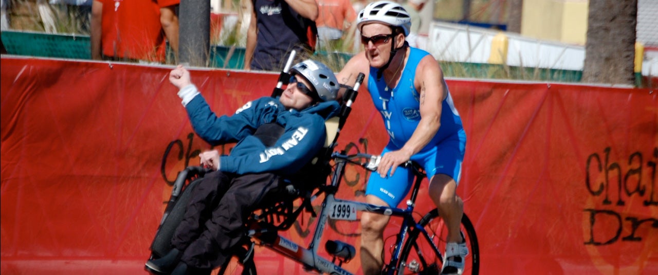 Dick Hoyt and son, Rick, crossing finish line at a triathlon