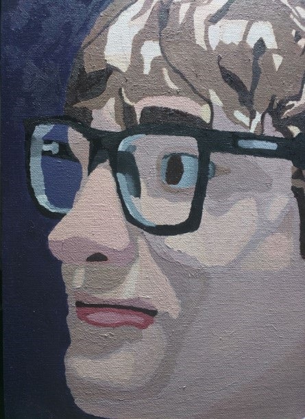 Photo of stanley's self portrait that he painted. It is a closeup of his face with a slight smile.
