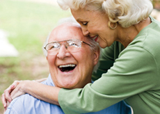 Elderly woman huggin elderly man