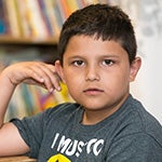 A young boy looking straight ahead