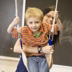 Boy on swing spotlight