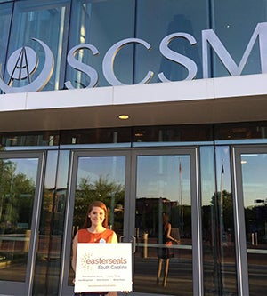 Mary Margaret holding an Easterseals sign