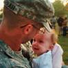 Military service member holding child
