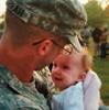 Military service member holding child