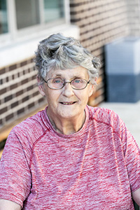 An older woman sitting outside
