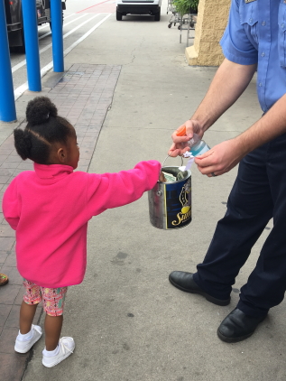 little girl giving donation 