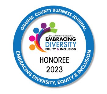 A circular badge with the words "Orange County Business Journal Embracing Diversity, equity and inclusion honoree 2023"