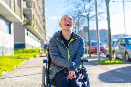 A man in a wheelchair smiling