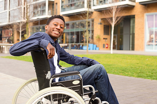 Smiling Man Sitting In Wheelchair