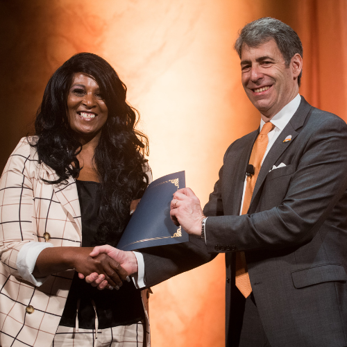 President & CEO Jon Horowich handing an award certificate to Head Start Assistant Teacher, Donna Chase.