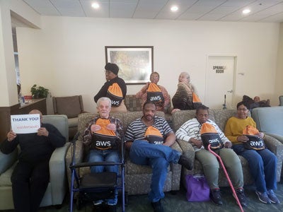 two women assemble care packages at Amazon Web Services meeting