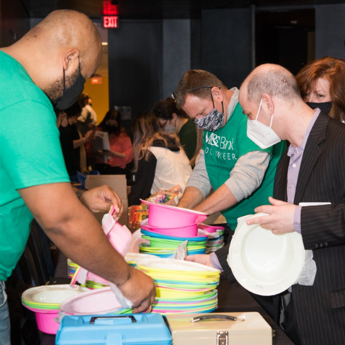 M&T Bank volunteers helping set up a table of fun giveaways at Bright Stars.