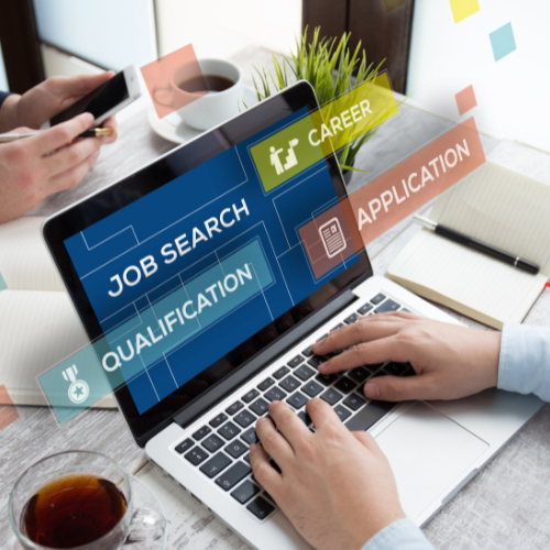 Someone typing on their computer with steps of the job search process on screen.