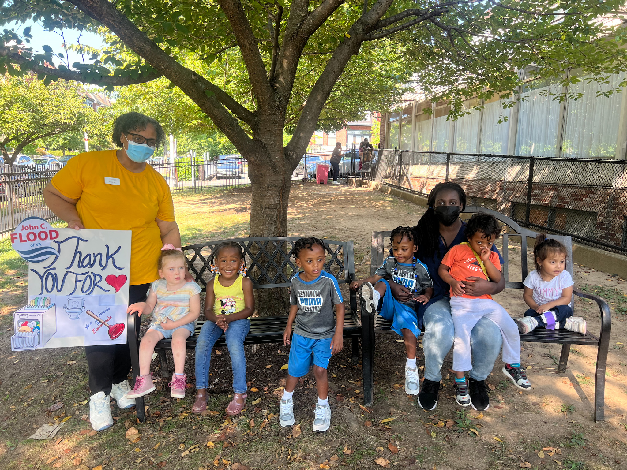 CDC students and teachers holding a thank you John C. Flood sign