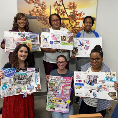 Military caregivers pose with 2020 vision boards