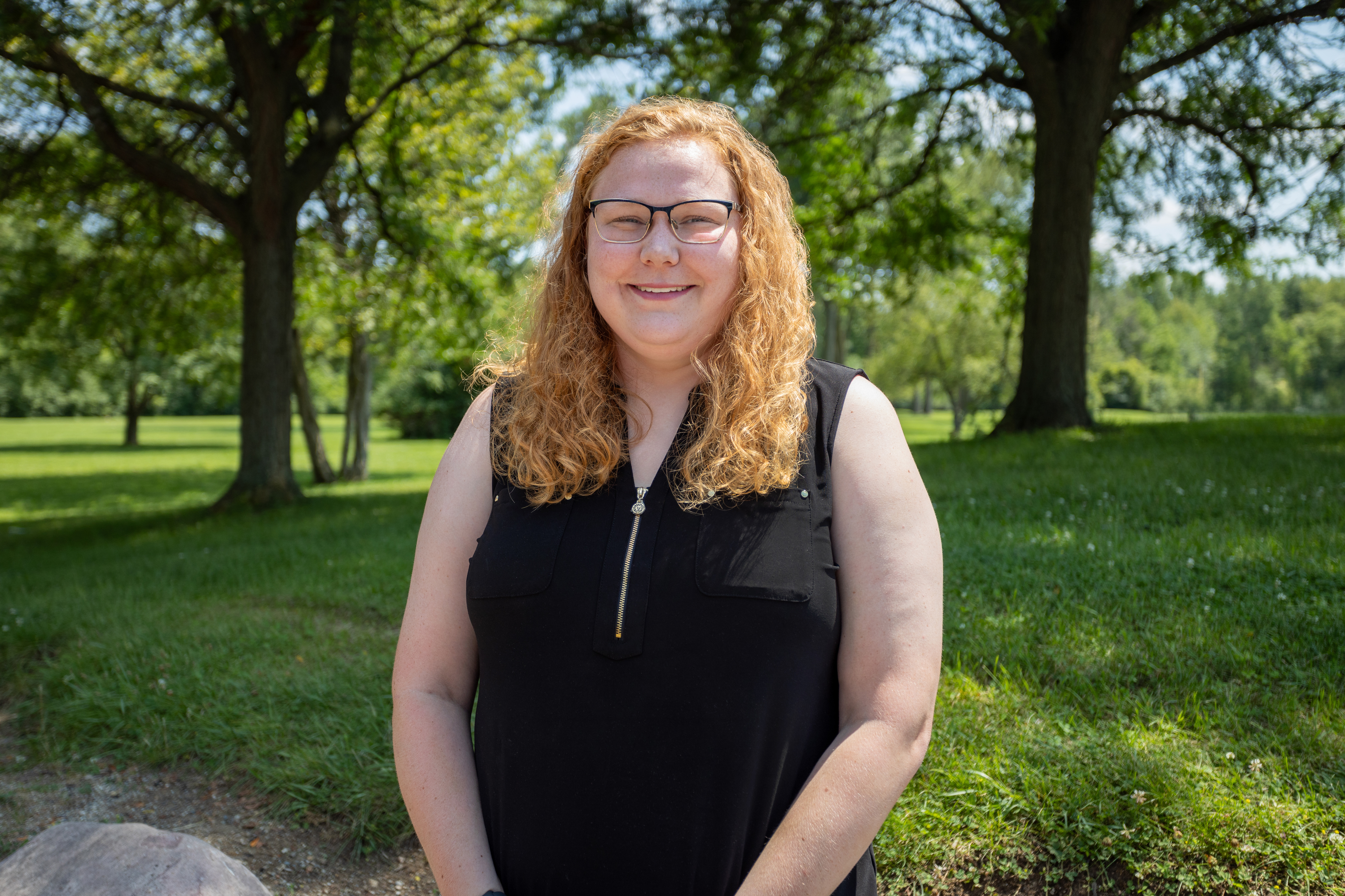 image of young adult female with red curly hair and glasses