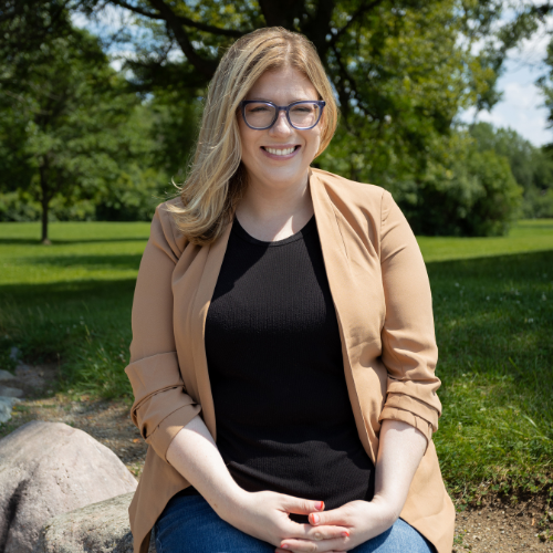 Photo of ambassador woman, sitting down in sunshine