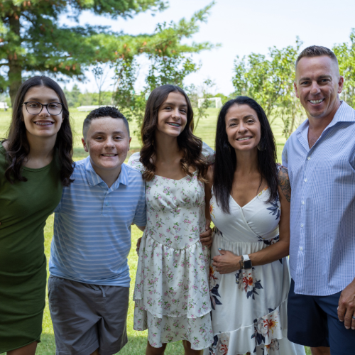 Sam with his sisters and parents