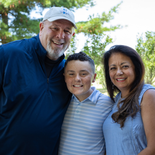 Sam posing for a picture with his grandparents