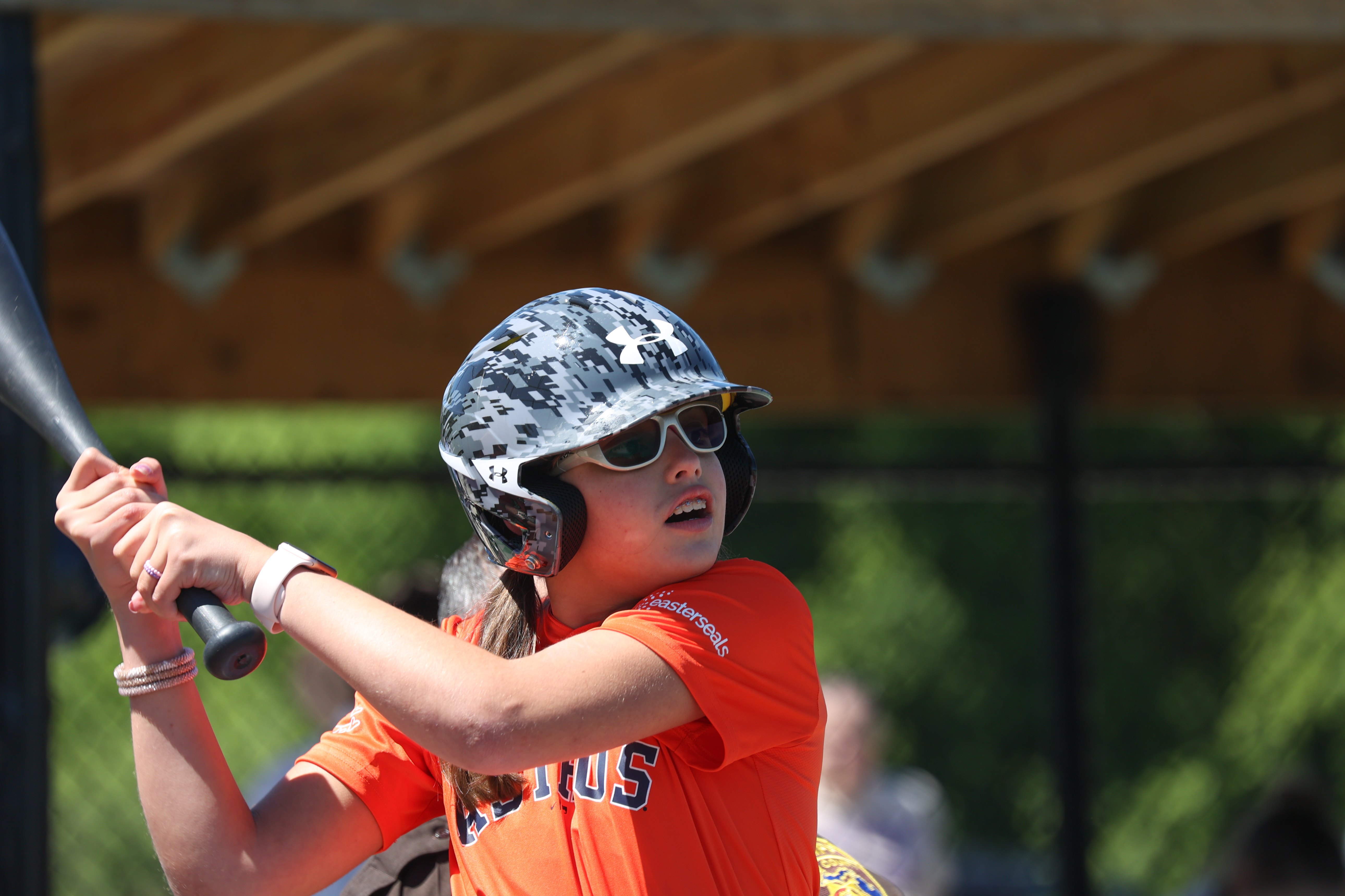 Allison with bat hitting at the Ribbon Cutting Event