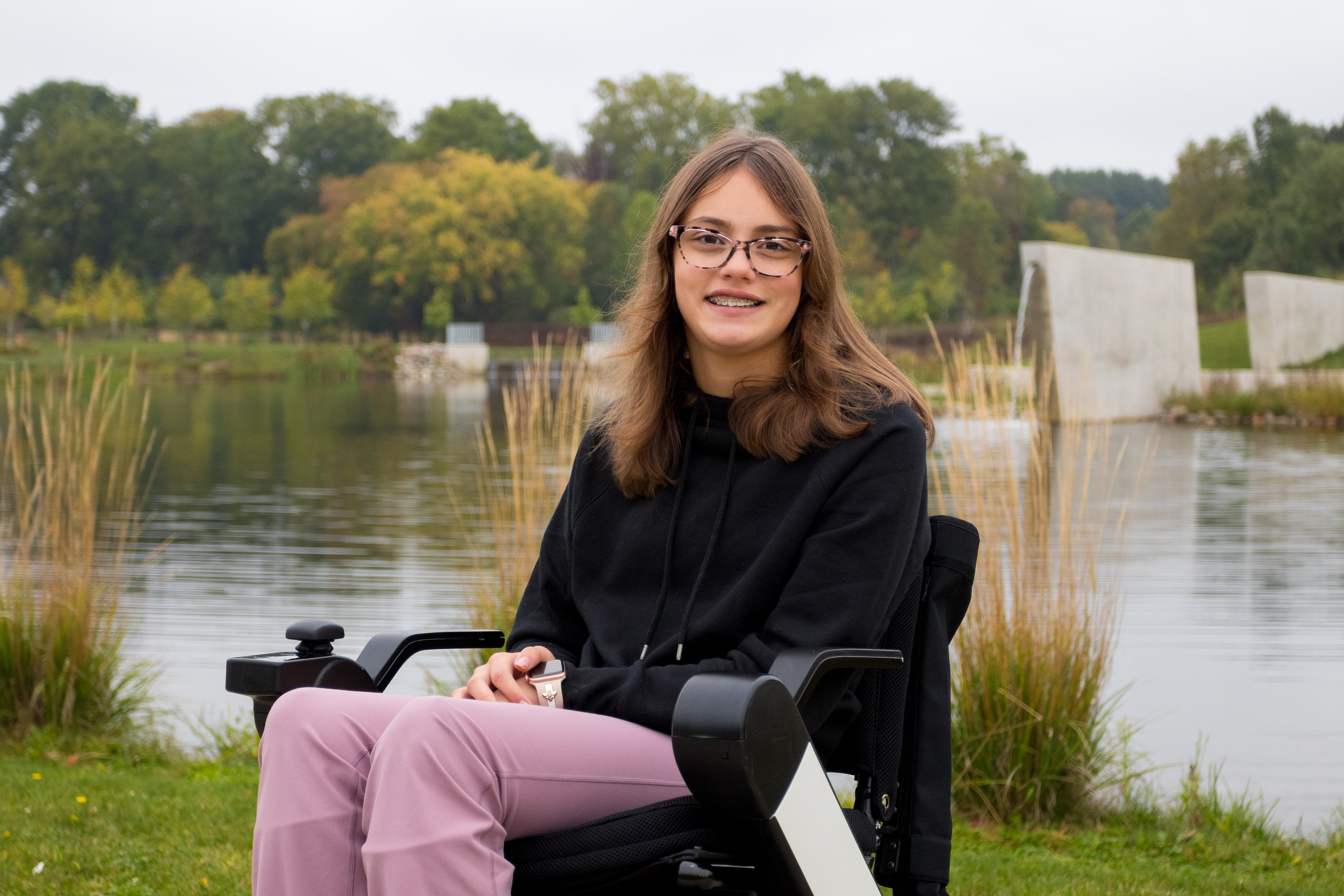 image of Allison at a park with a pond in the background