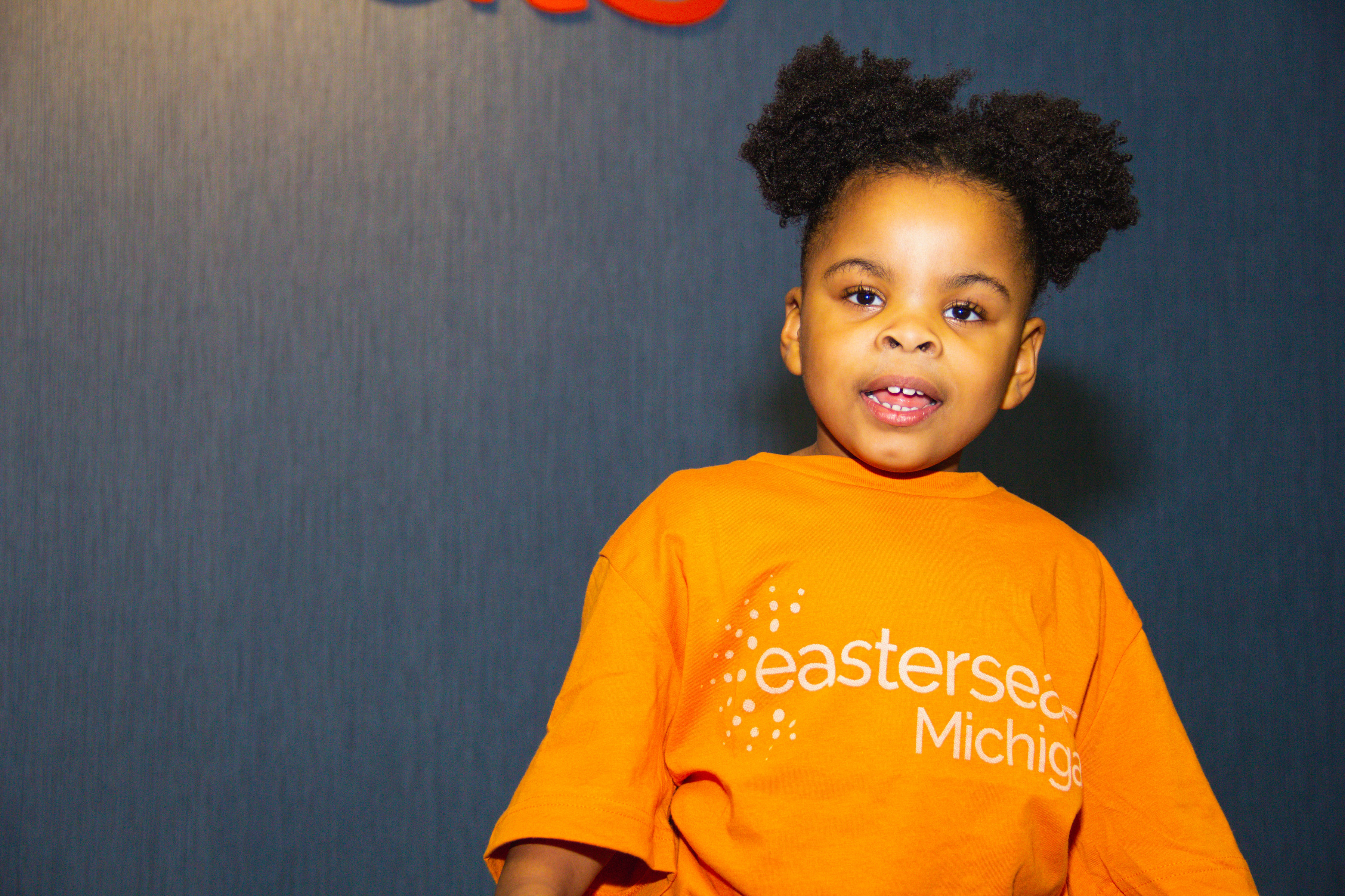 Ariel, young girl ambassador, looking down and smiling