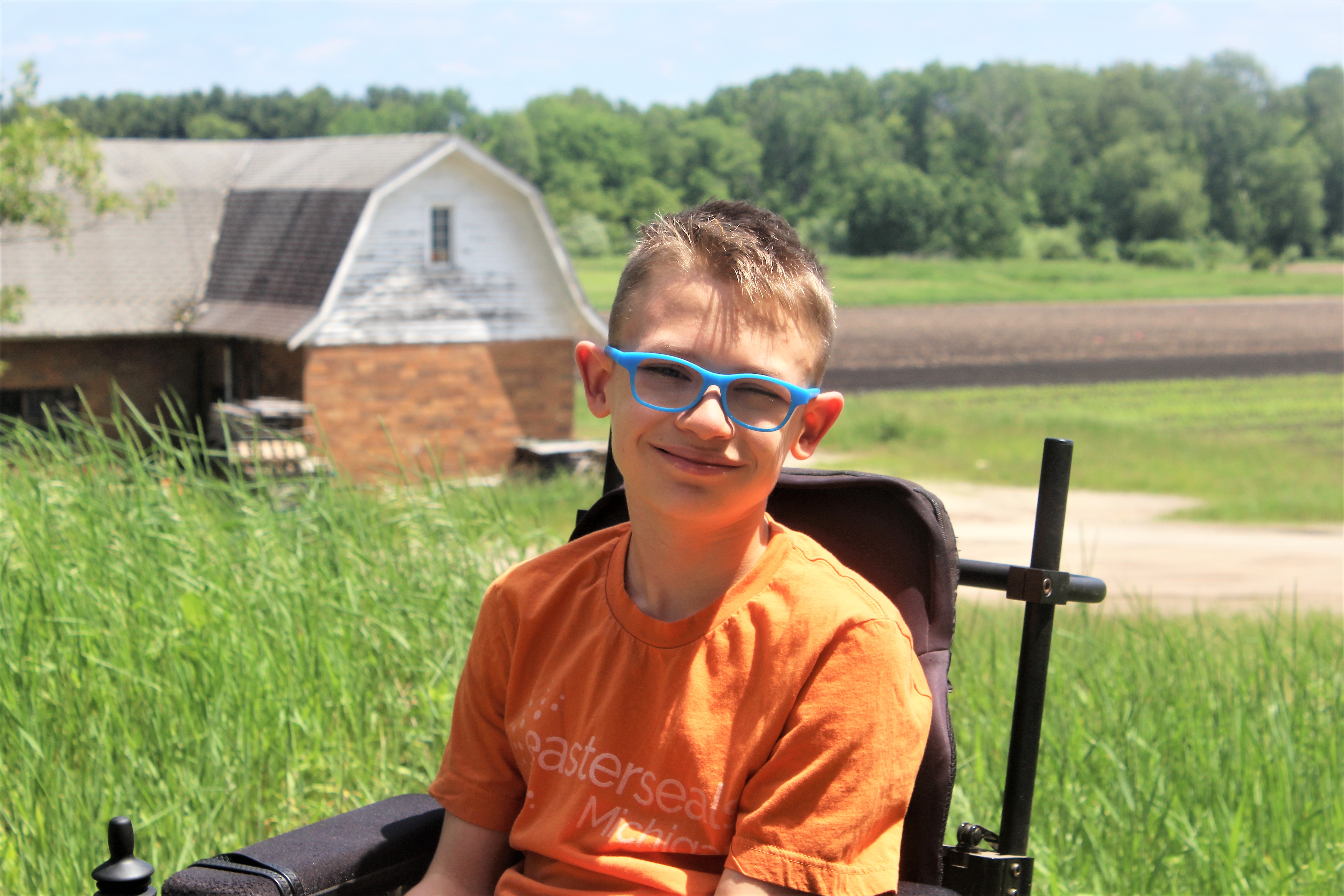 Orange shirt farm background smile 