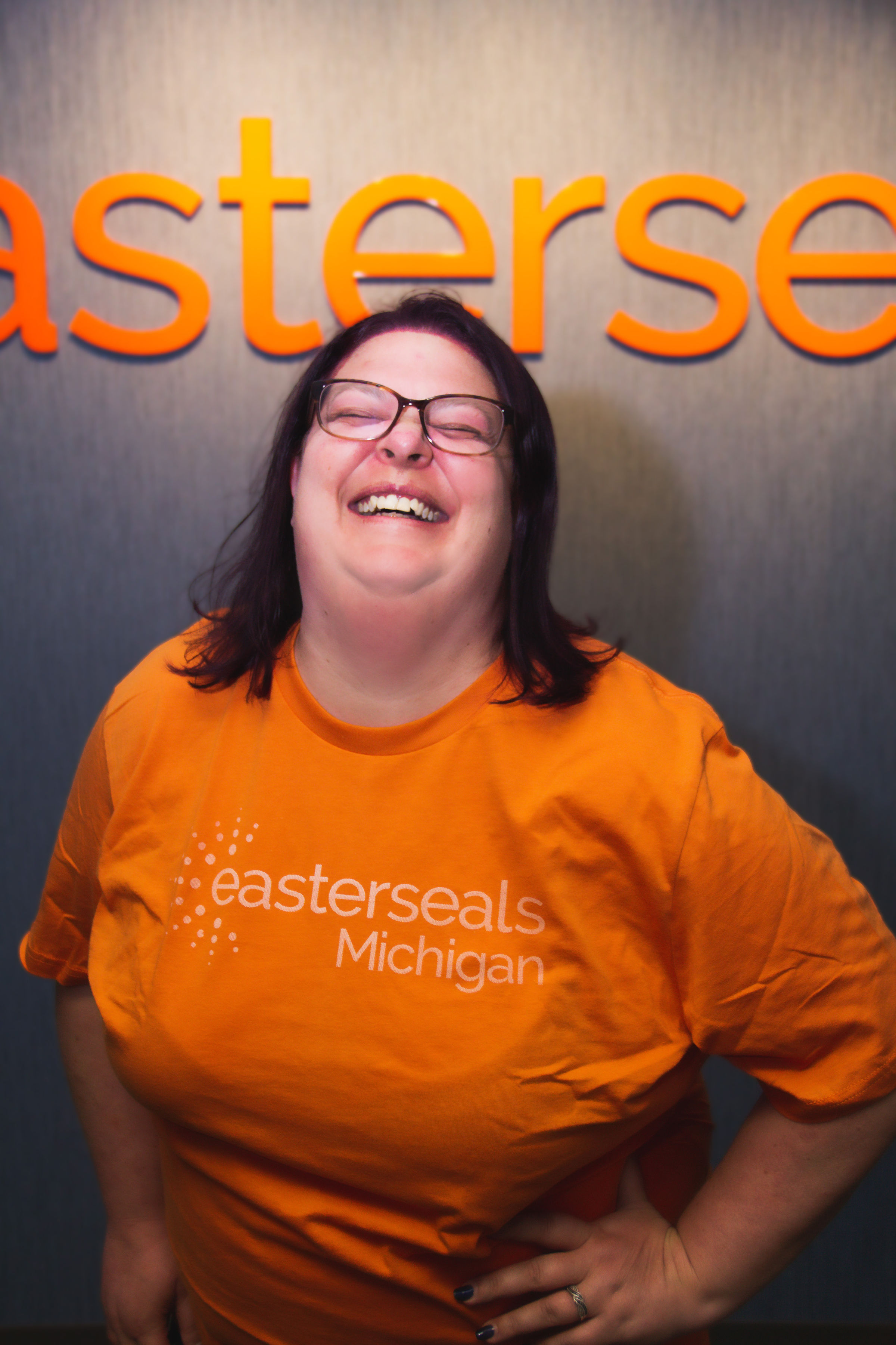 Jenn in orange ESM shirt laughing 