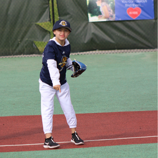 throwing ball while in blue jersey