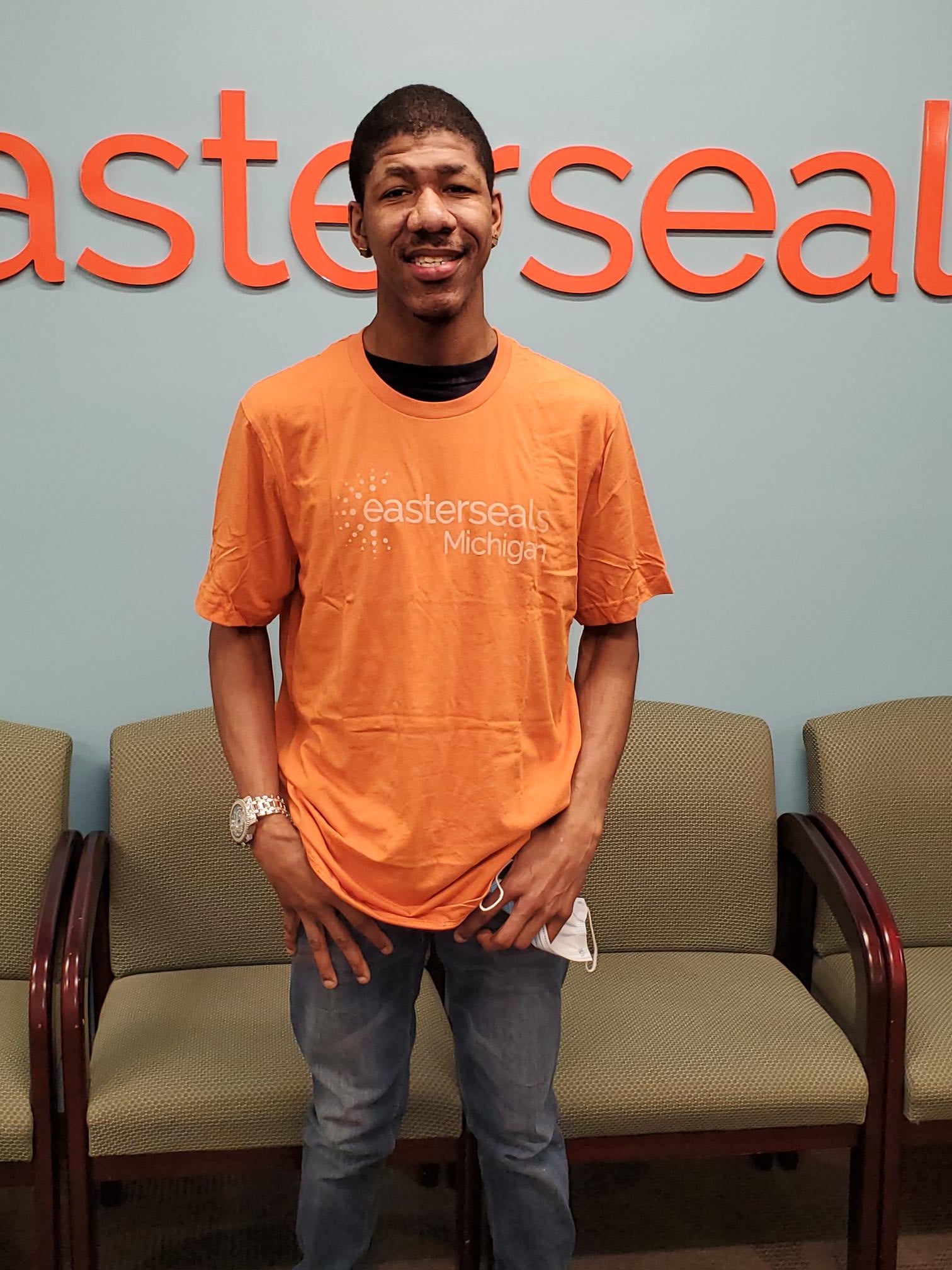justin in esm orange shirt smiling