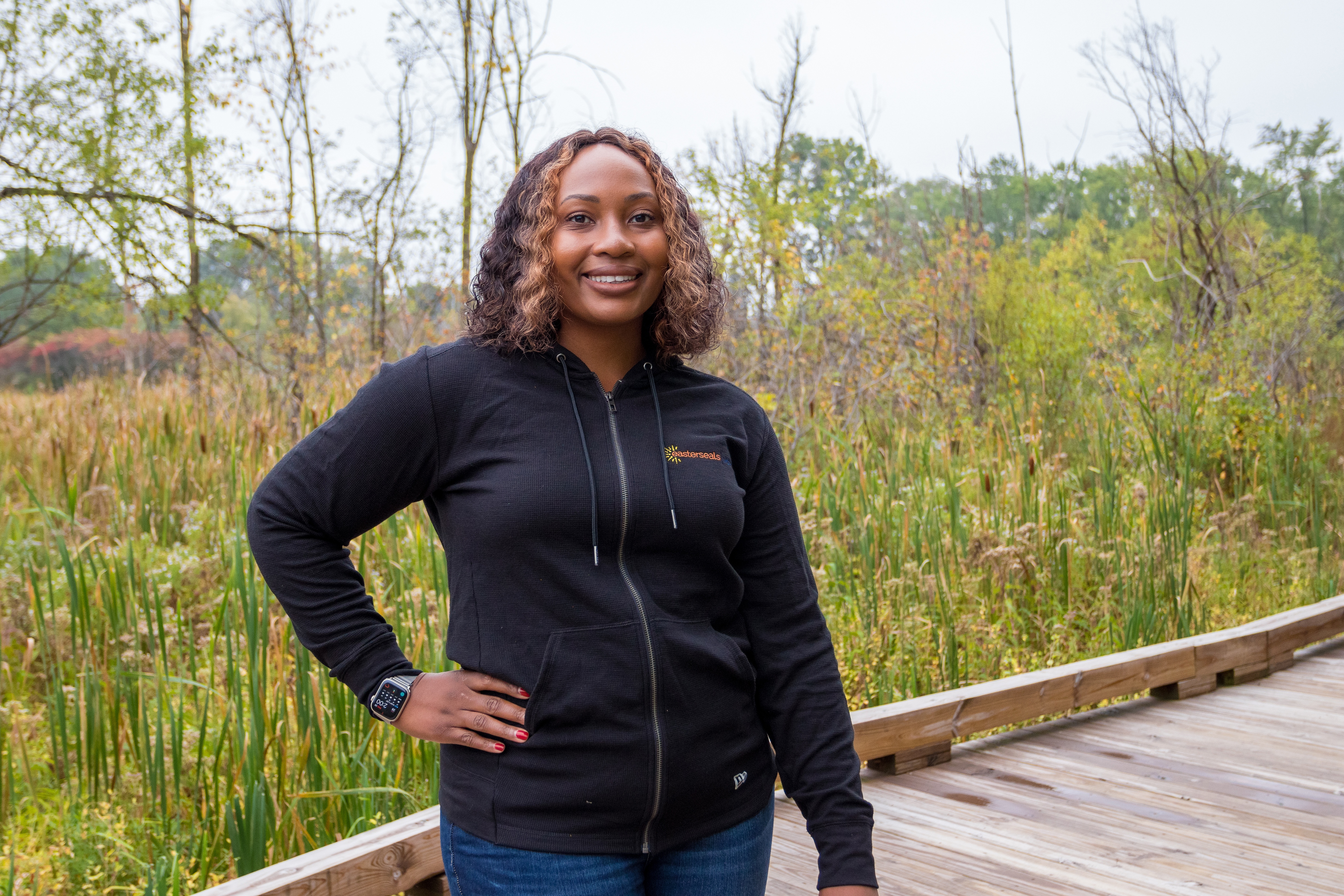 Kiauna smiling with hand on hip at photoshoot