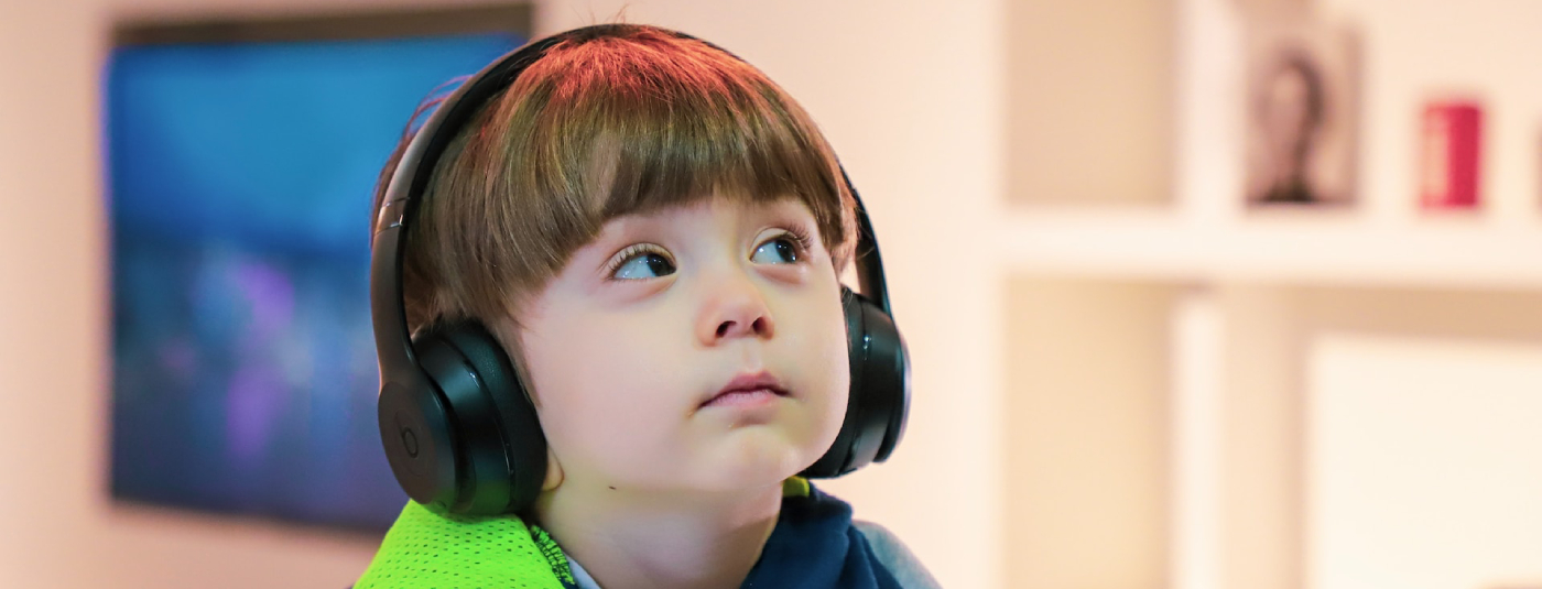 Little boy with headphones listening to music