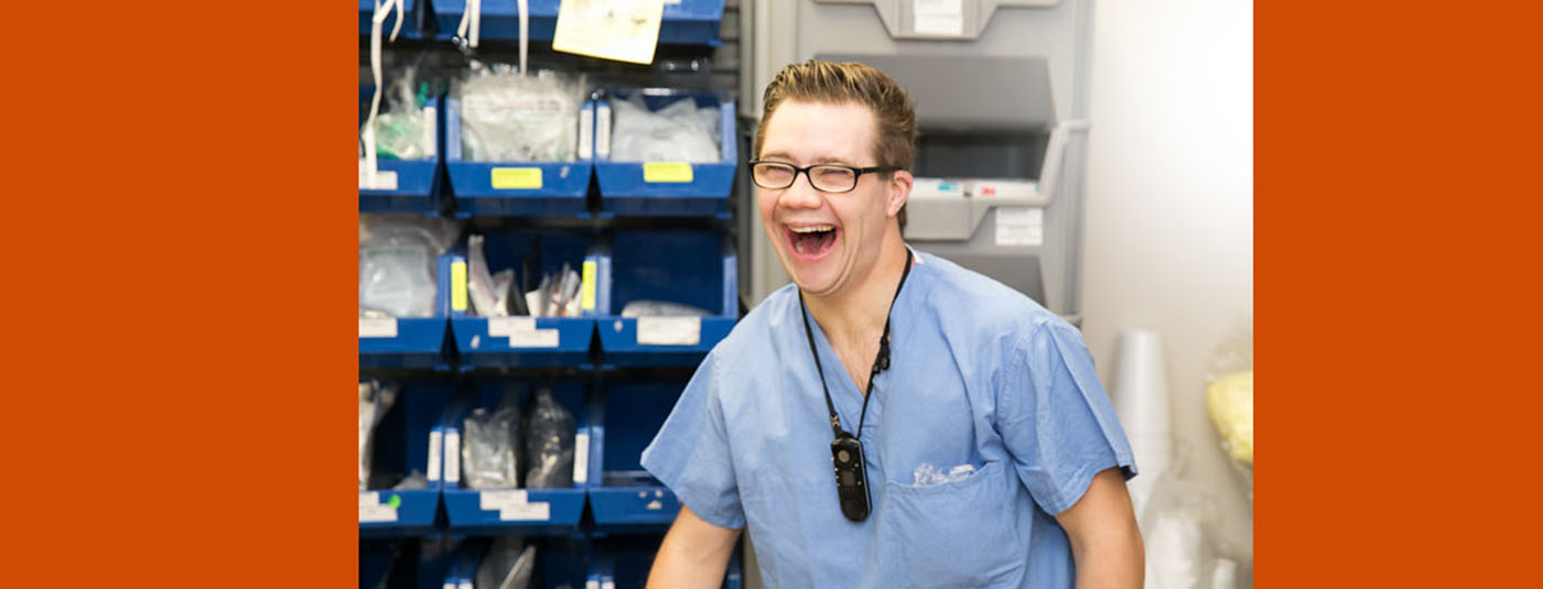 man in blue medical scrub clothes laughing