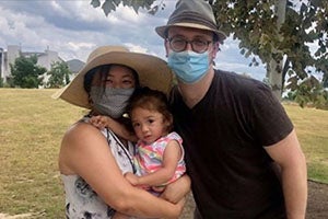 woman and man holding a toddler