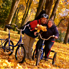 two people in fall leaves