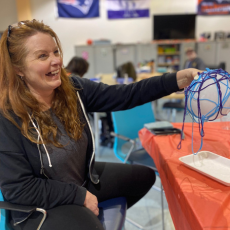 a woman sitting at a table and smiling