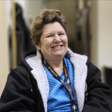 a participant smiling for the camera in the NRADP main hall