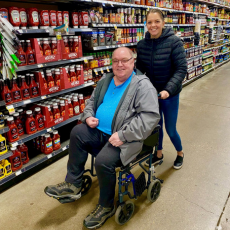 a participant and staff member in the grocery store
