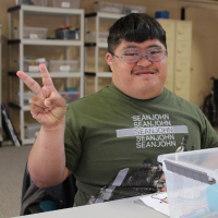 an explorers participant holding up a peace sign