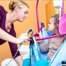 a woman is helping to move a young girl in a transfer swing