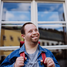 a man in front of a window smiling