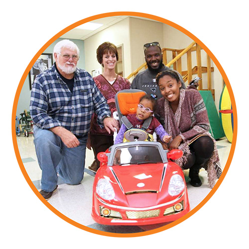 Mark Lobach, AKA Easterseals’ Santa, loves seeing children, like Journey Parson (center), experience independence for the first time in their modified ride-on car. Journey is pictured with her Easterseals therapist, Colleen Heckman, and her parents, Rich and Patrice Parson of Smyrna.