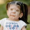 Girl with pigtails and printed white and blue dress