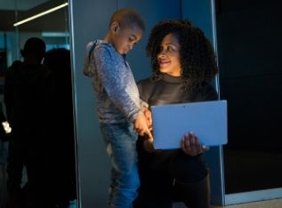 child and mother looking at computer