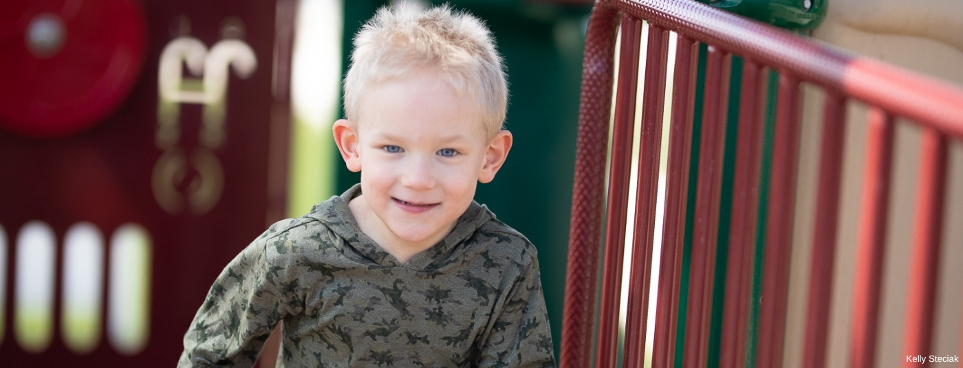 Boy smiling running outside 