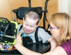 Scottie in Assistive Technology with Therapist